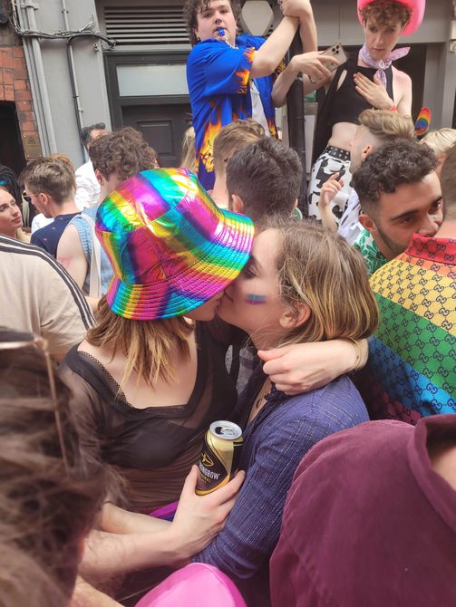 Lucy and her girlfriend, kissing amongst the crowds of Pride 2022.