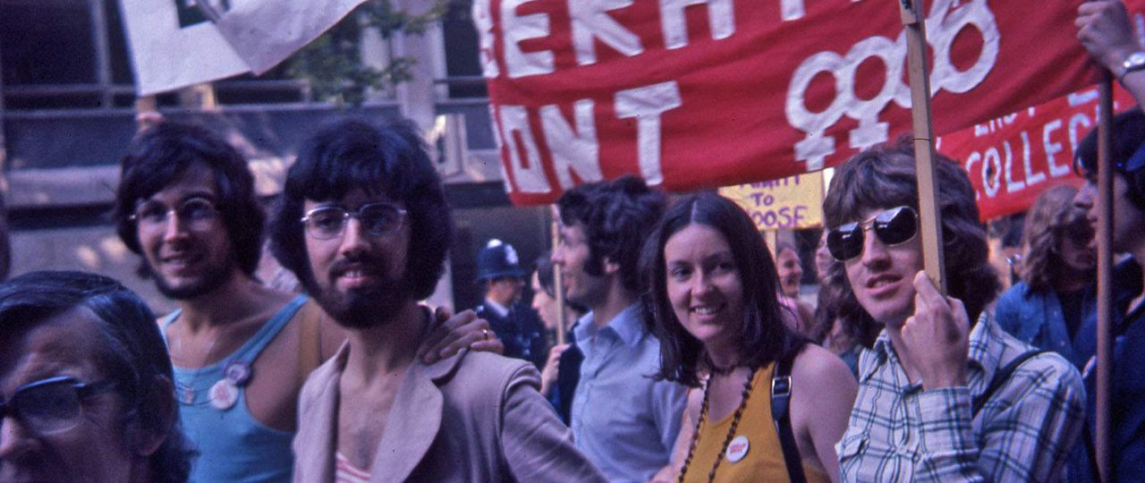 Image from our collections of some people holding signs at a protest.
