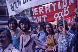 Image from our collections of some people holding signs at a protest.