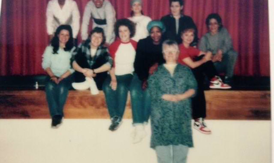 A scan of a photo from the Clean Break archive of a group of people gathered on a stage.