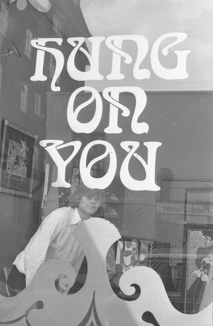 The outside of a shop front, with the words "Hung on You" in the window.
