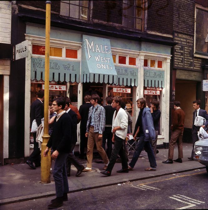 A photo of "Male West Ones" shop on Carnaby Street, people are milling around outside the shop front.