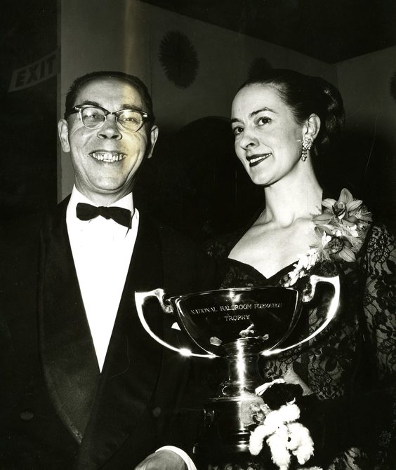 Peggy Spencer and her husband Frank holding a trophy.
