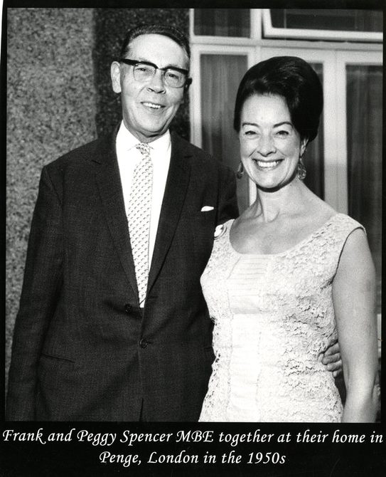 A black and white image of Peggy and her husband Frank. Underneath the image, it says: "Frank and Peggy Spencer mBE together at t heir home in Penge, London in the 1950s".