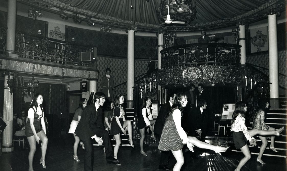 A group of people dancing on stage, with this image taken from the Peggy Spencer Archive.