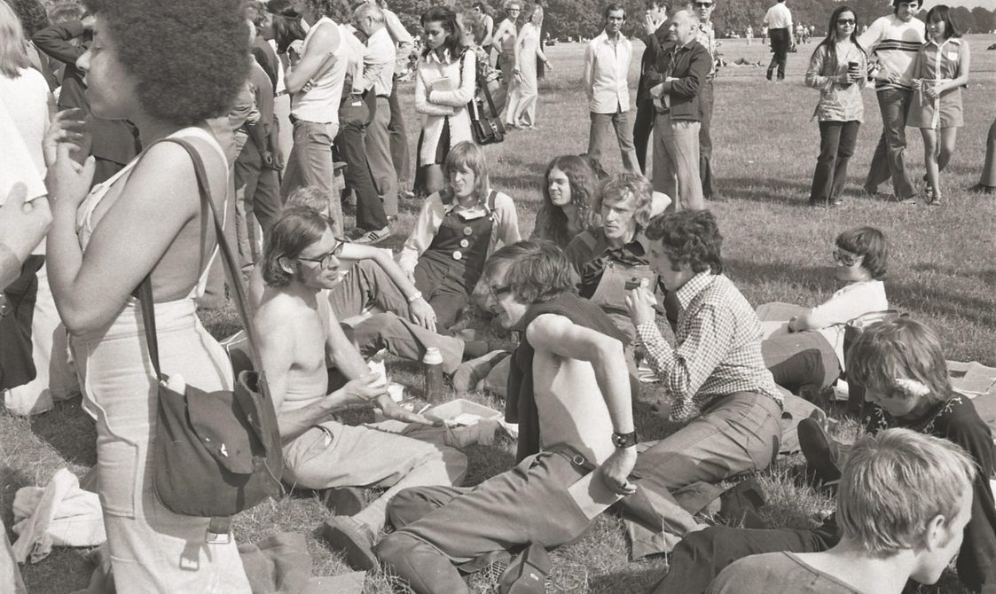 A picture from the second Pride march in 1973. A group of protestors are sitting in Hyde Park.