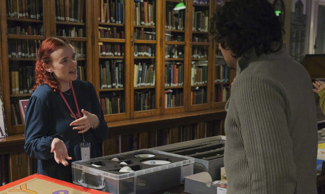 A Bishopsgate archivist discusses items from the archives with a member of the public.