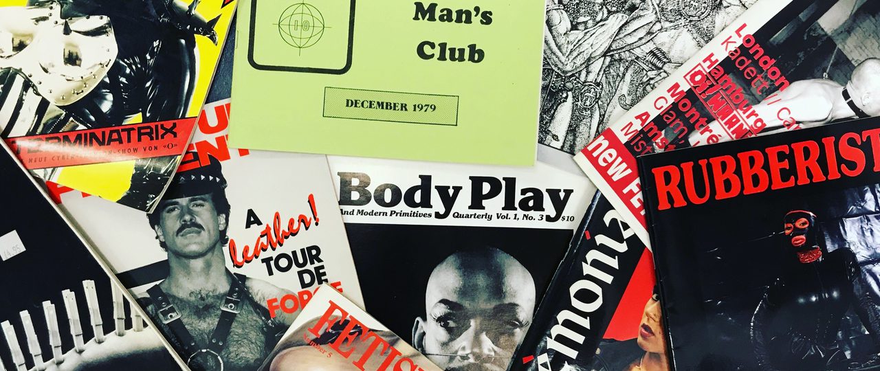 Pile of leather and Fetish magazines spread out.