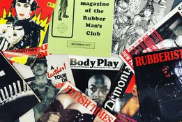 Pile of leather and Fetish magazines spread out.