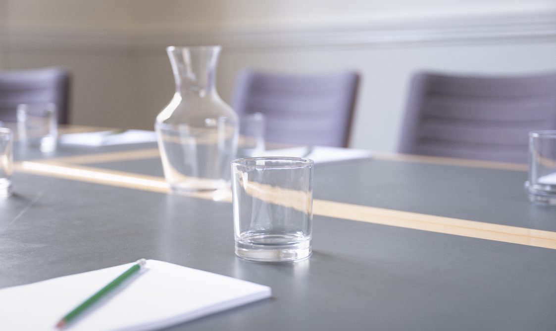 A photograph of Bishopsgate Institute's Townsend Room in central London. The image is focused on a waterjug and glasses on the desk.