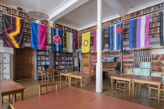 Internal view of Bishopsgates Institute Library with a display of brightly coloured flags