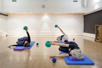 a group taking a Pilates class at Bishopsgate Institute, London
