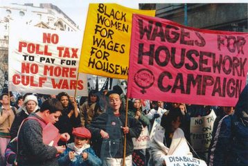 An image of a Wages for Housework protest march, showing women holding Wages for Housework banners.