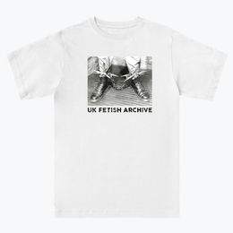 Black and white Image of someone's feet with boots on and spikey shackles around their ankles. On a white T-shirt from the UK Fetish Archive Merch.