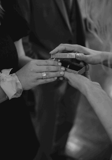 Exchanging rings at a micro-wedding in our Library, August 2024.